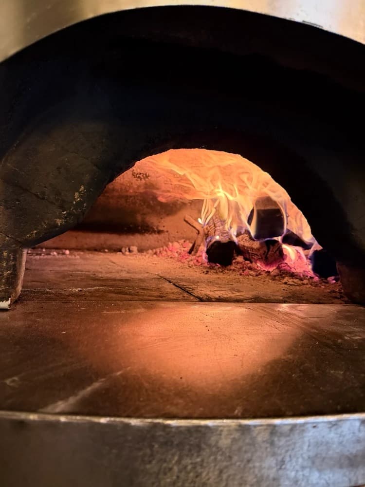 Feuer im Holzofen des Il Pomodoro